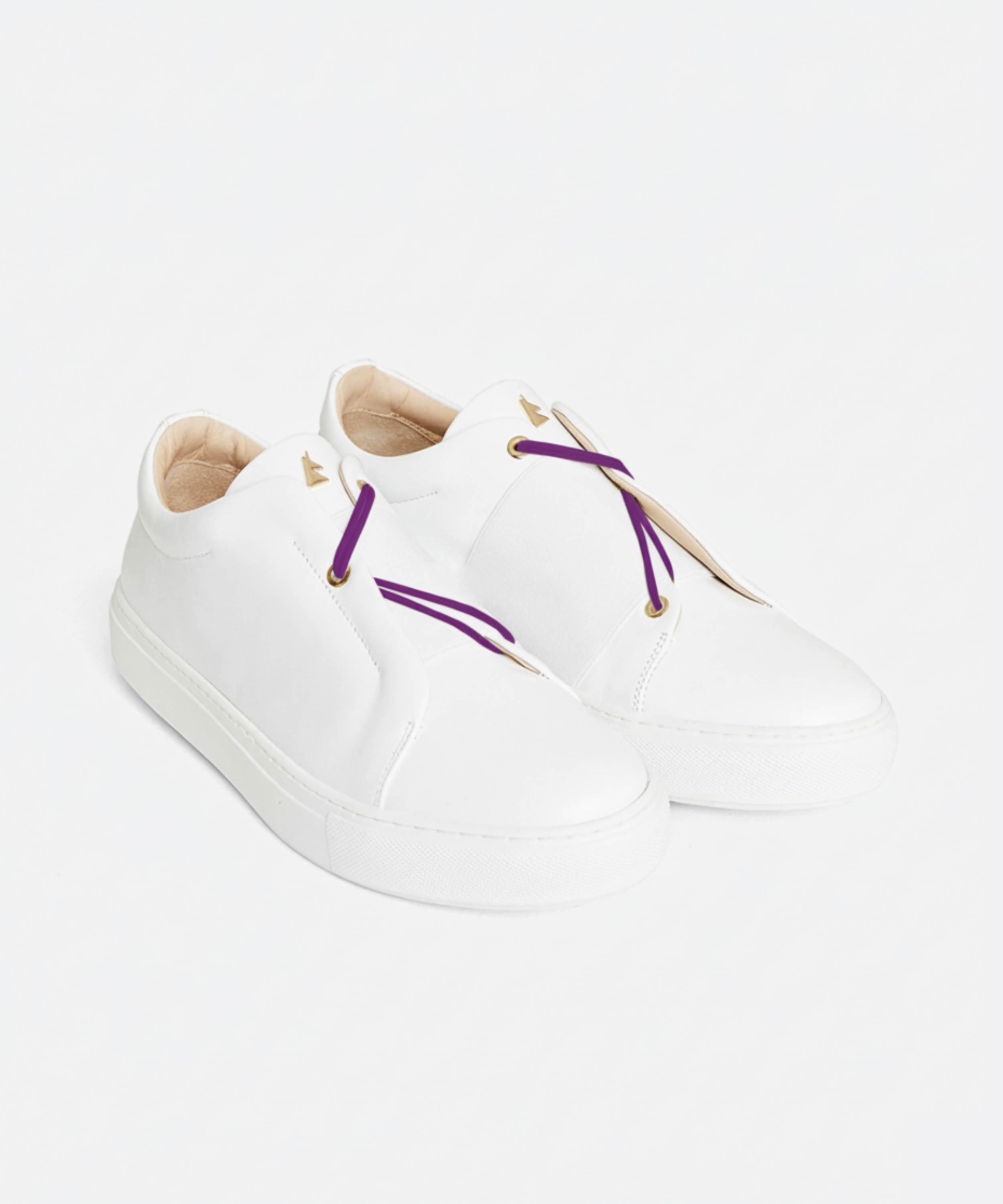 White sneakers with purple laces on a white background