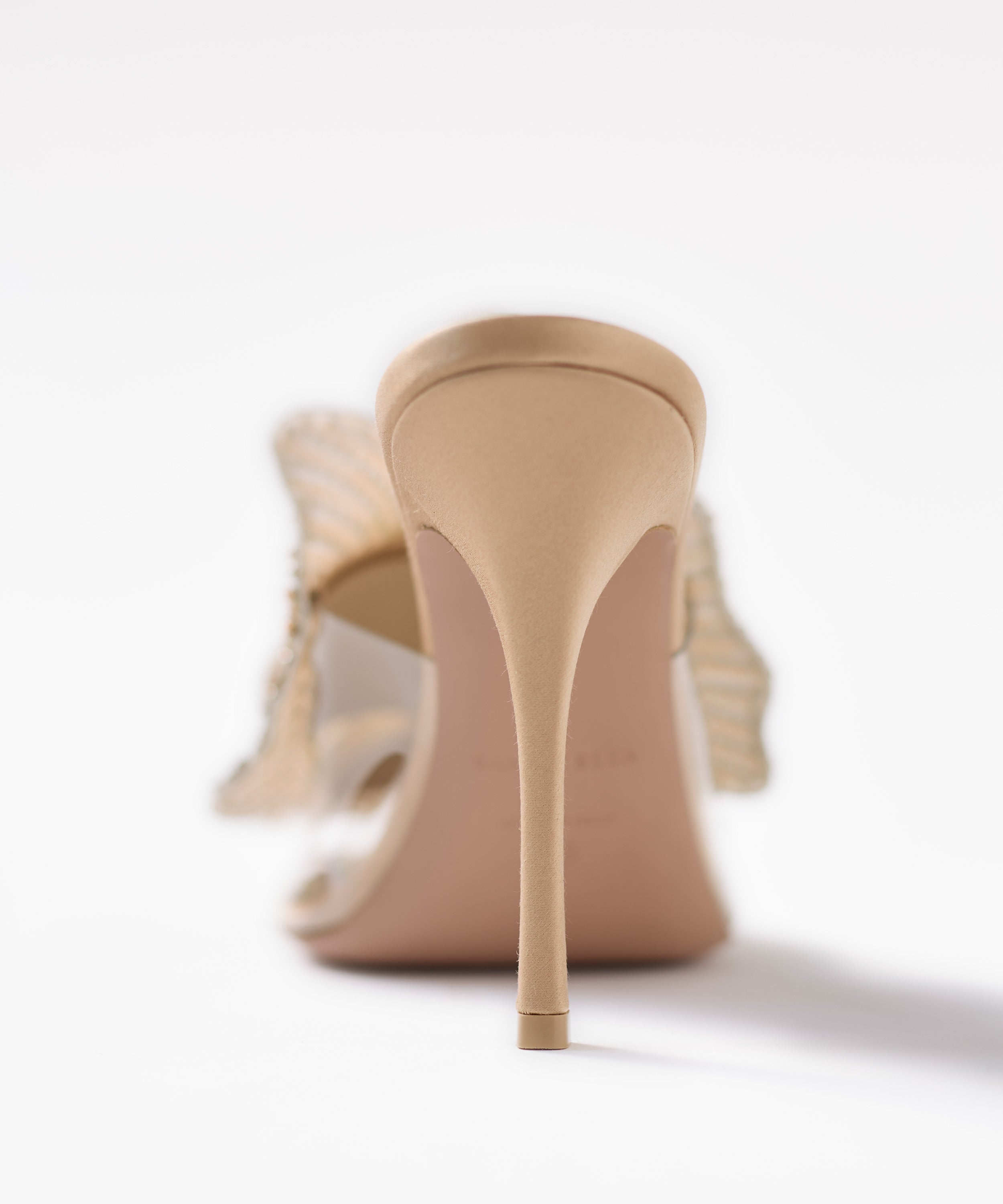 Beige high-heeled shoes on a white background