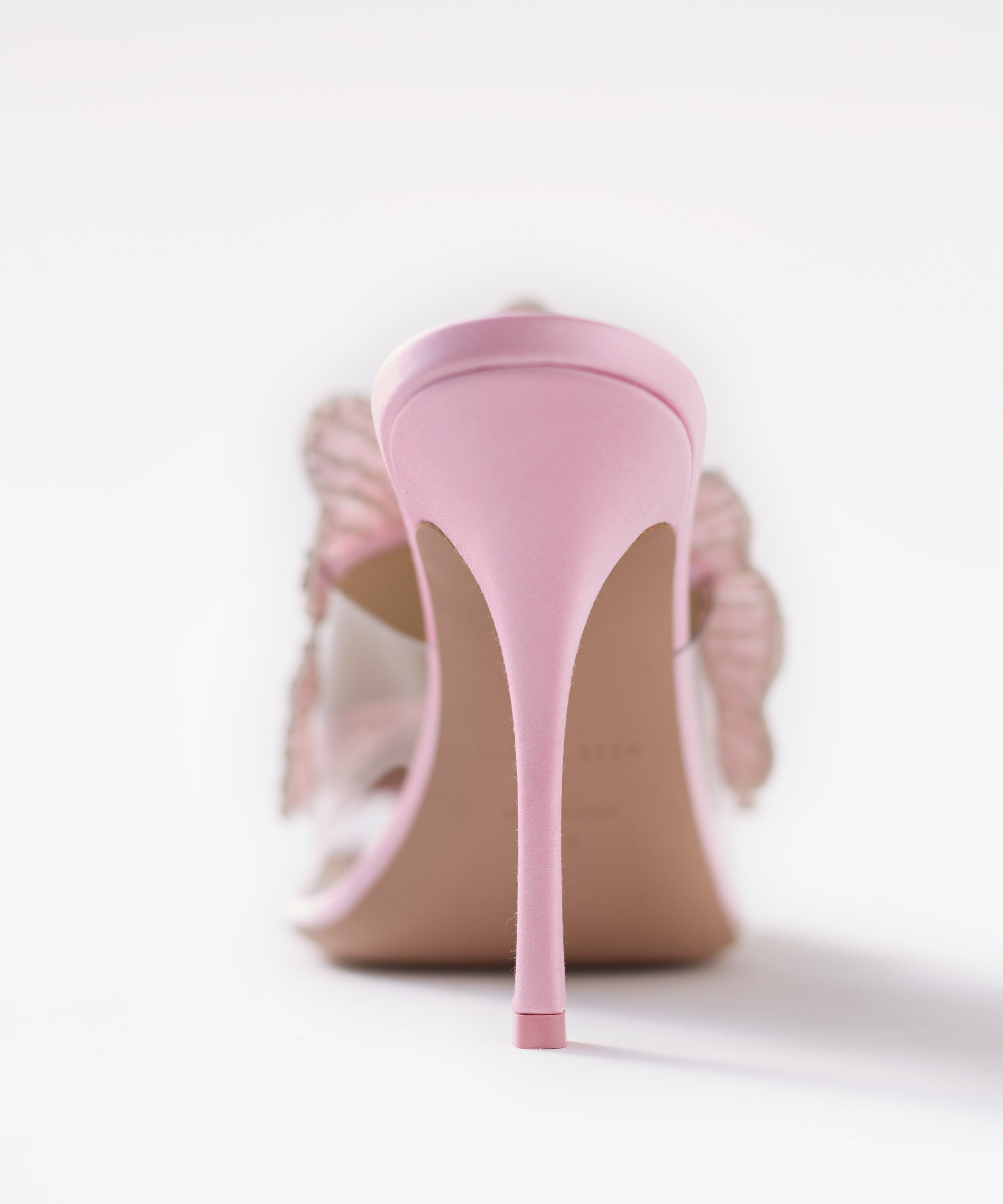 Pink high-heeled shoes on a white background